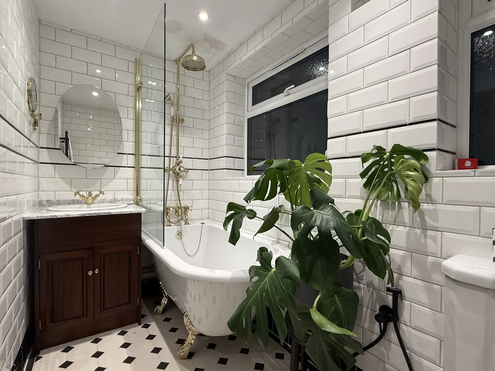 Period bathroom with clawfoot bath and brushed brass shower fittings