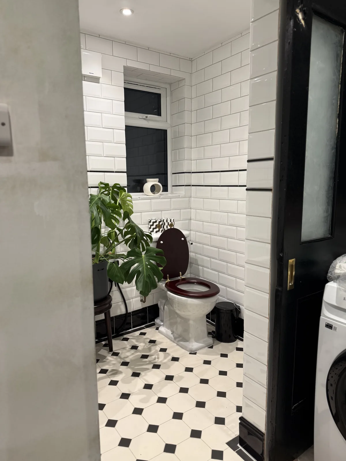 Black and white bathroom with metro tiles and octagon-and-dot floor tiles